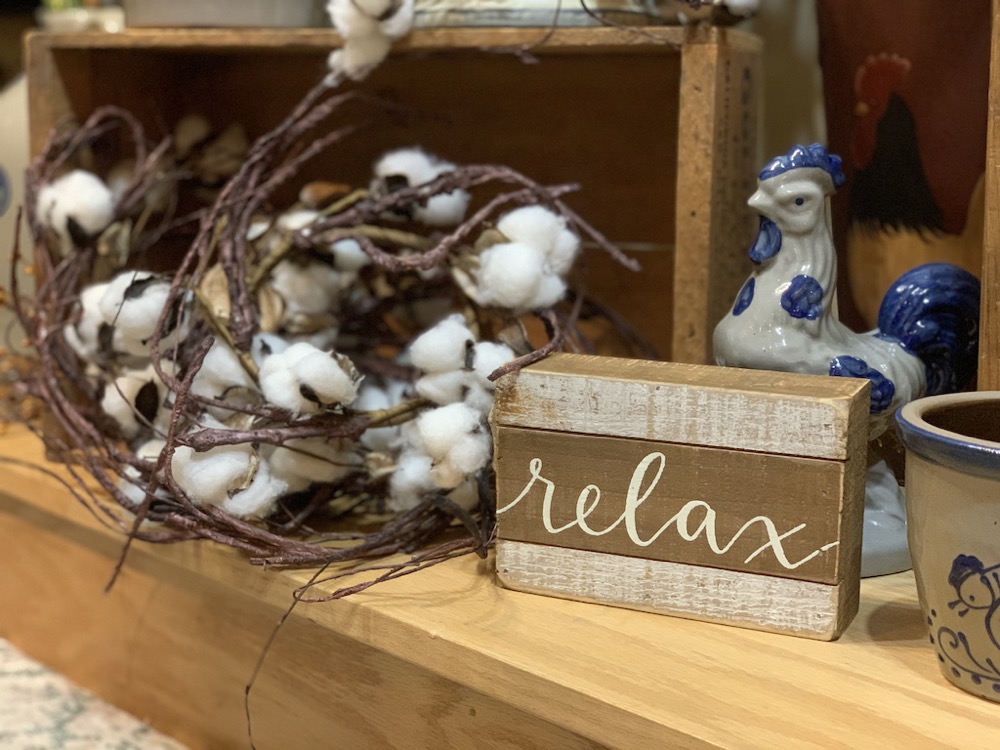 relax wood sign artificial plants and home decor items