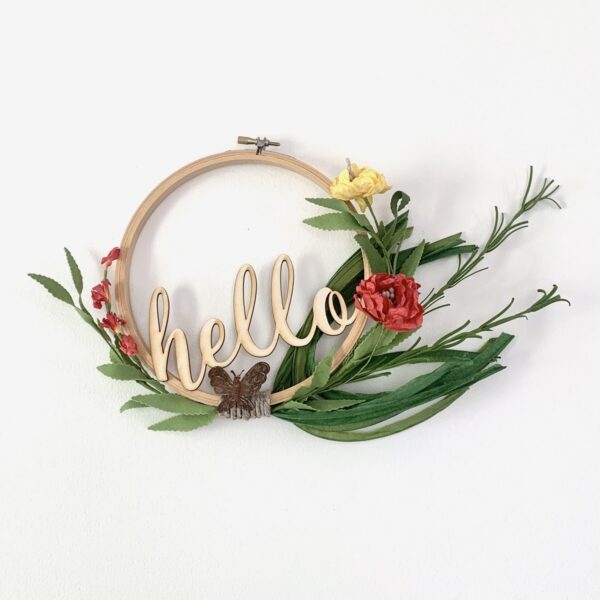 embroidery hoop hello sign with butterfly and bright flowers