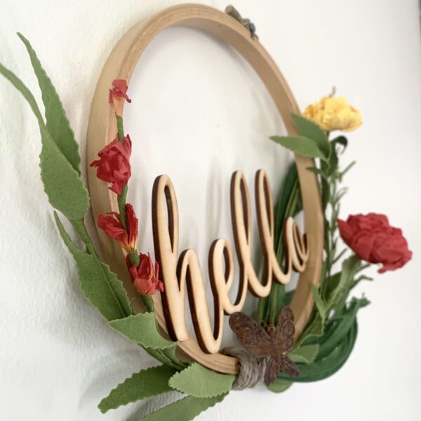 embroidery hoop hello sign with butterfly and bright flowers angle