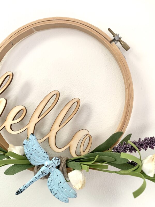 embroidery hoop hello sign with dragonfly and lavender sprigs close up