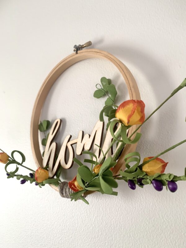 embroidery hoop home sign with orange flowers angle