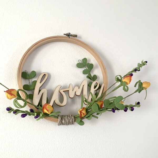 embroidery hoop home sign with orange flowers close up