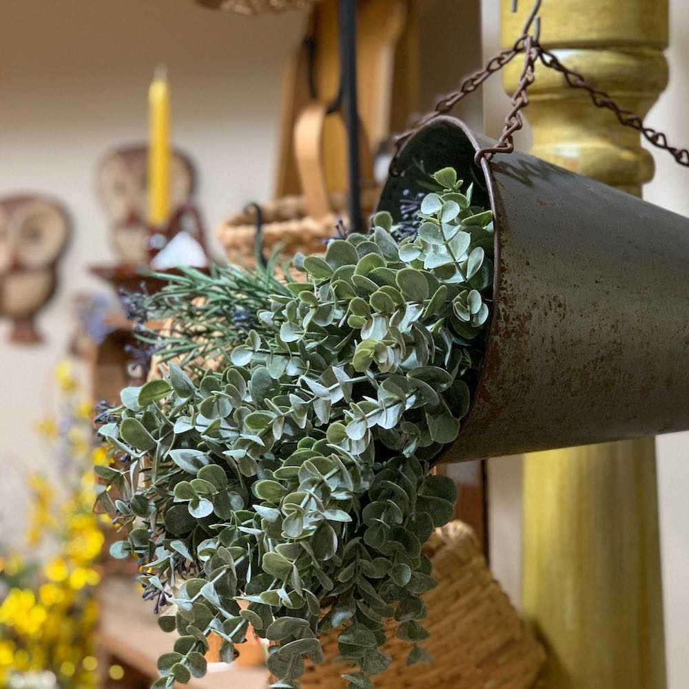 eucalyptus stems in a vintage metal container